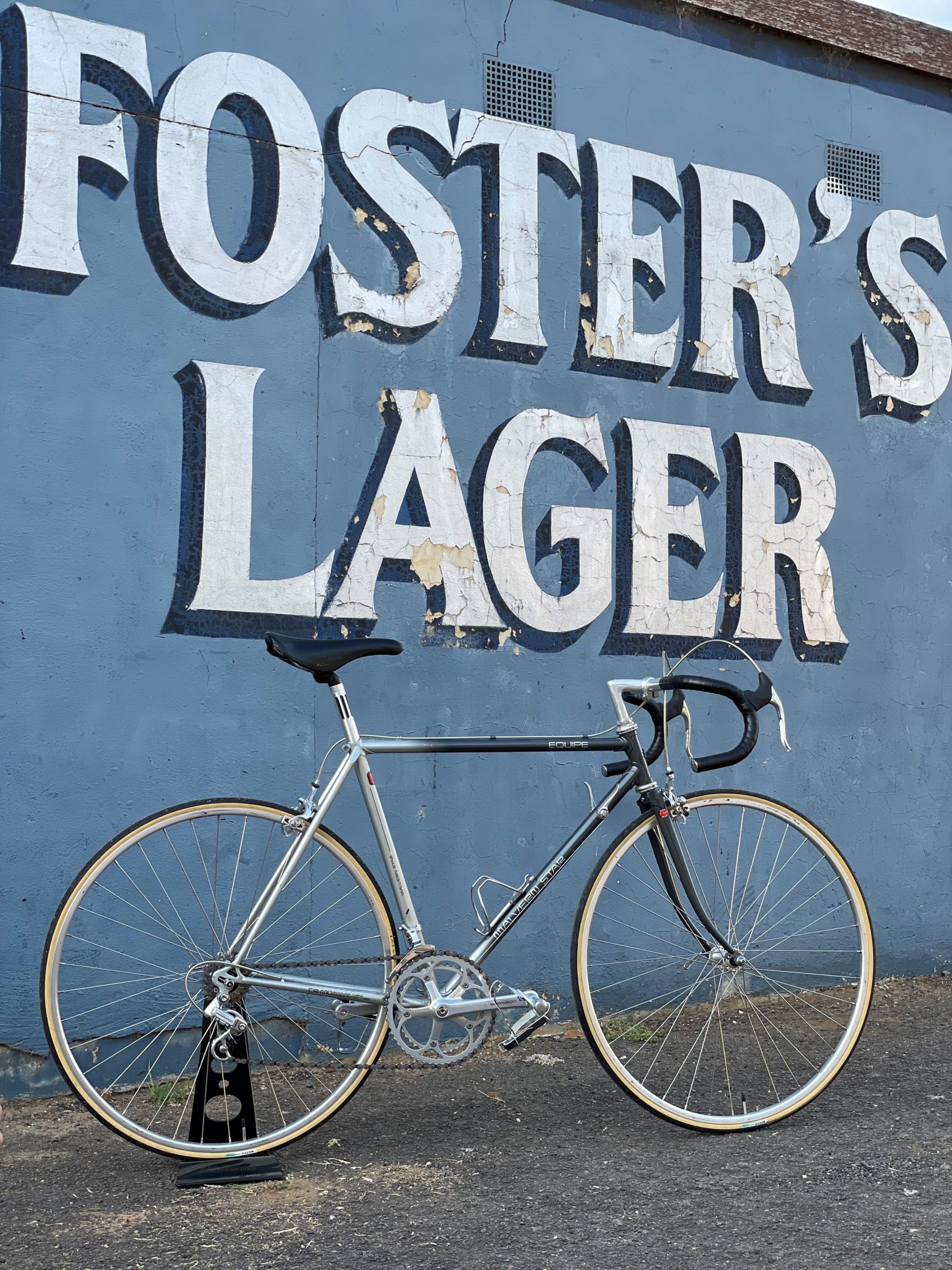 Bicycle in front of Foster's sign
