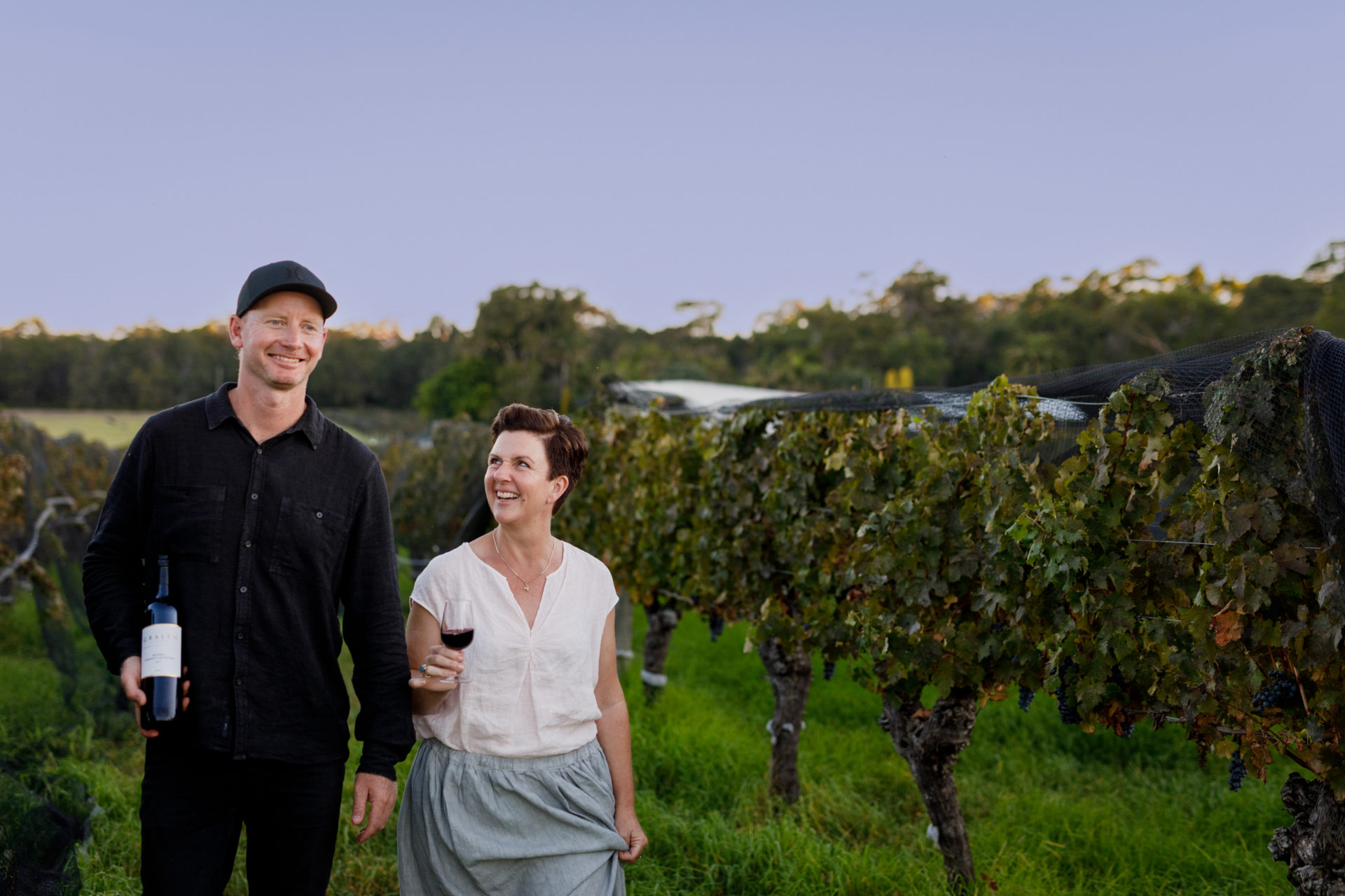 Scott and Annette Baxter walking through vineyard