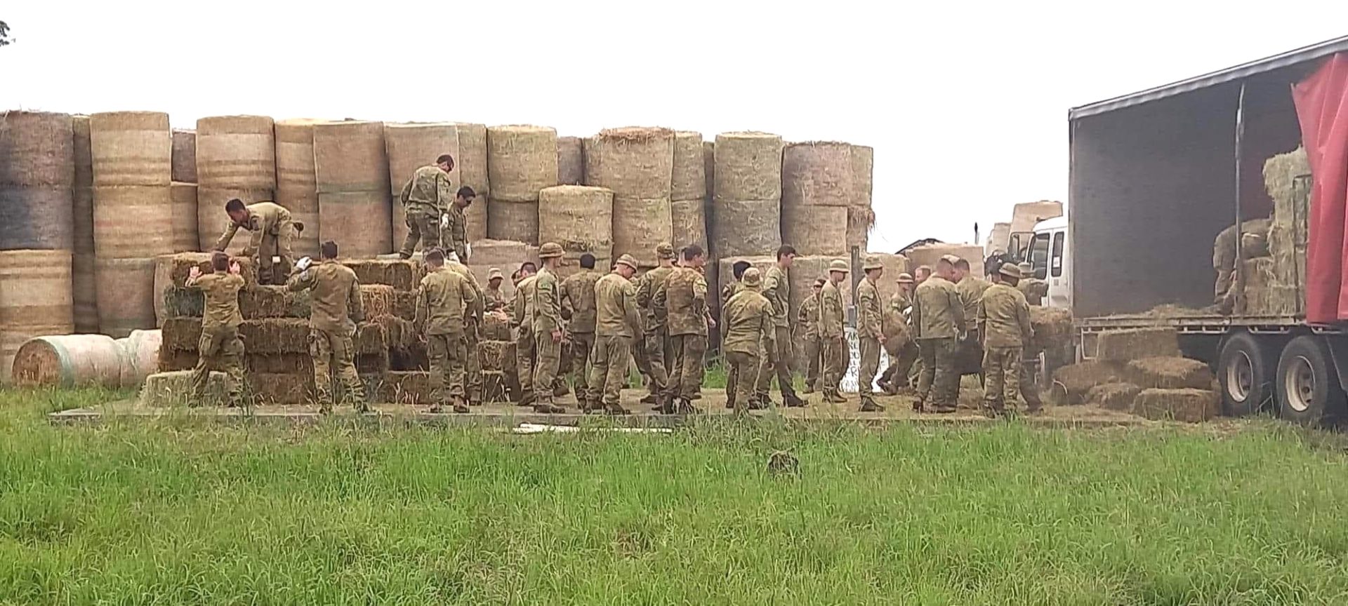 Army moving hay bales