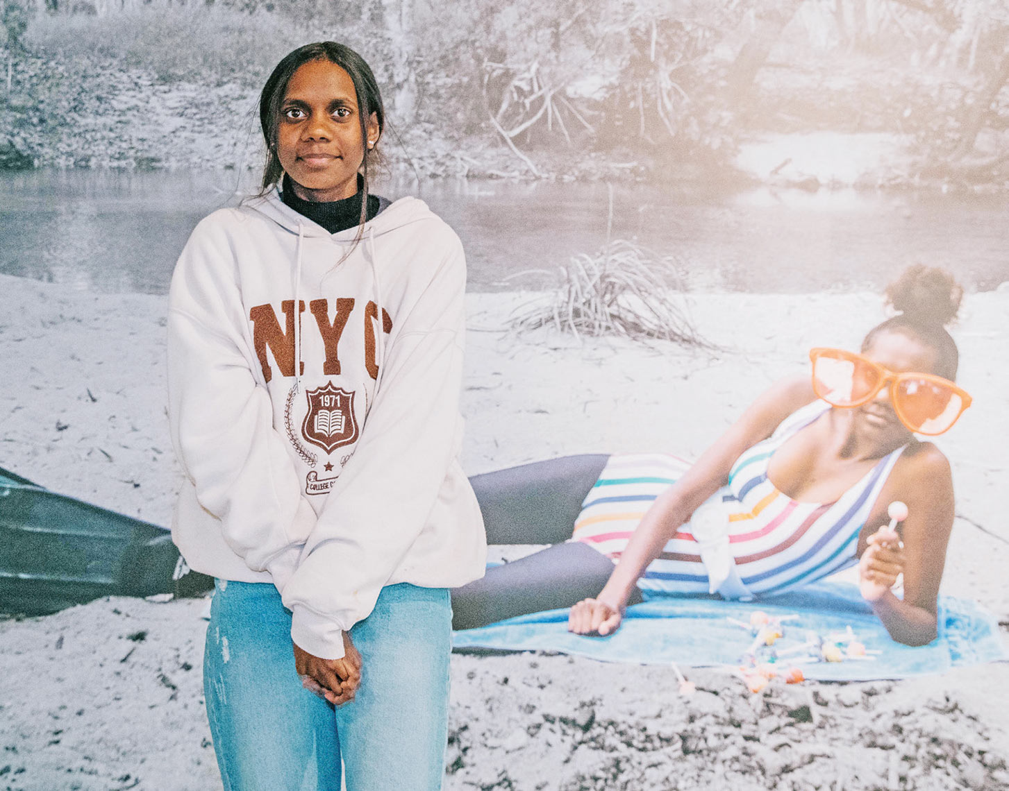 Verona Platt stands in front of the photo taken by Naomi Hobson on the banks of Coen Creek.