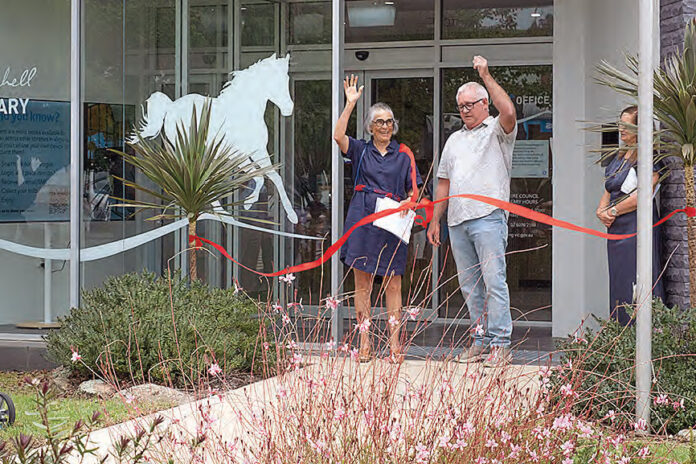 Honor Auchinleck and Towong mayor, Cr Peter Tolsher, cut the ribbon at the re-opening of the Corryong library
