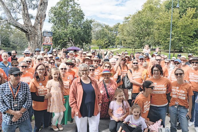 Michelle Milthorpe (centre) with her community supporters has indicated she will nominate for the Farrer byelection